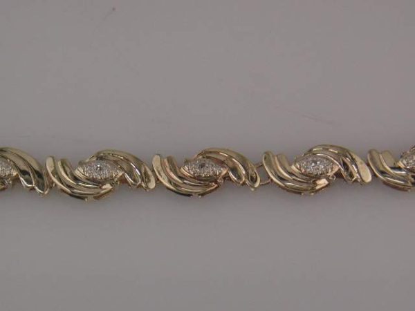 14K Y/G DIAMOND BRACELET. 7.2 GRAMS. DIA:0.13 PTS.