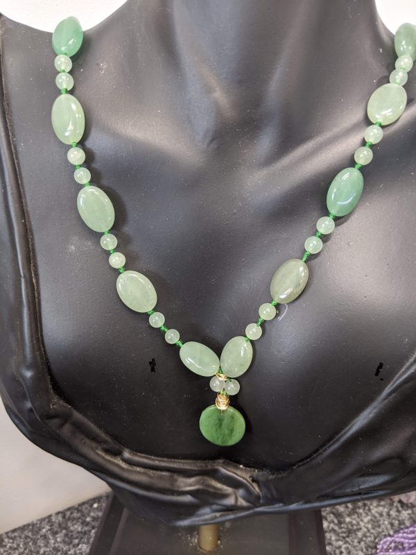 46" BEADED LIGHT JADE NECKLACE WITH DARKER JADE PENDANT.
