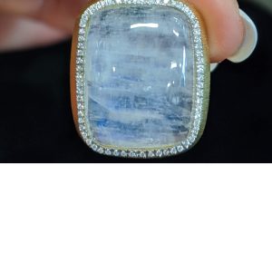 18K Y/G AND DIAMOND (70 PTS) PENDANT WITH OBLONG MOONSTONE CABOCHON (26 X 20MM) WITH HINGED BALE. WEIGHS 12.2 DWT