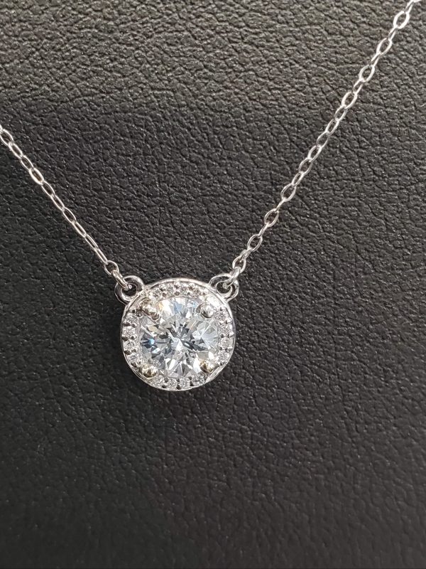14K WHITE GOLD LADIES NECKLACE FEATURING A MINE GROWN ROUND BRILLIANT CUT CENTER DIAMOND WEIGHING 0.75 PTS WITH A MICRO PAVE HALO CONSISTING OF 0.15 PTS OF RBC'S. APPROX 0.90 PTS TCW. COLOR:G , CLARITY:SI.