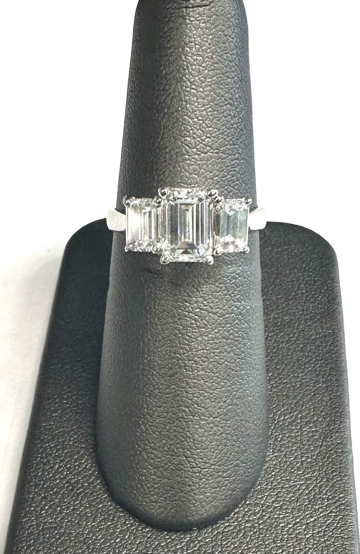 PLAT. EMERALD CUT ENGAGEMENT RING 3 EMERALD CUTS CENTER IS 1.50 CTS. 2 SIDE EMERALD CUT DIAMONDS ARE .50PTS EACH. 2.50CTS. ALL DIAMONDS COLOR:F-G , CLARITY: VS1. 3.2 DWT.