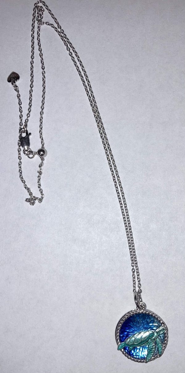 NICOLE BARR STERLING SILVER, TEAL SEA TURTLE PENDANT WITH BLUE WAVES. COMES WITH A STERLING SILVER ADJUSTABLE 20" CHAIN.