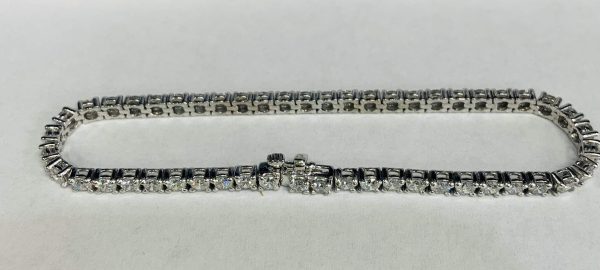 14K W/G LADIES 7.25" LAB GROWN TENNIS BRACELET FEATURING 5.00 CARATS OF ROUND BRILLIANT CUT DIAMONDS. GOLD WEIGHT: 6.1 DWT.