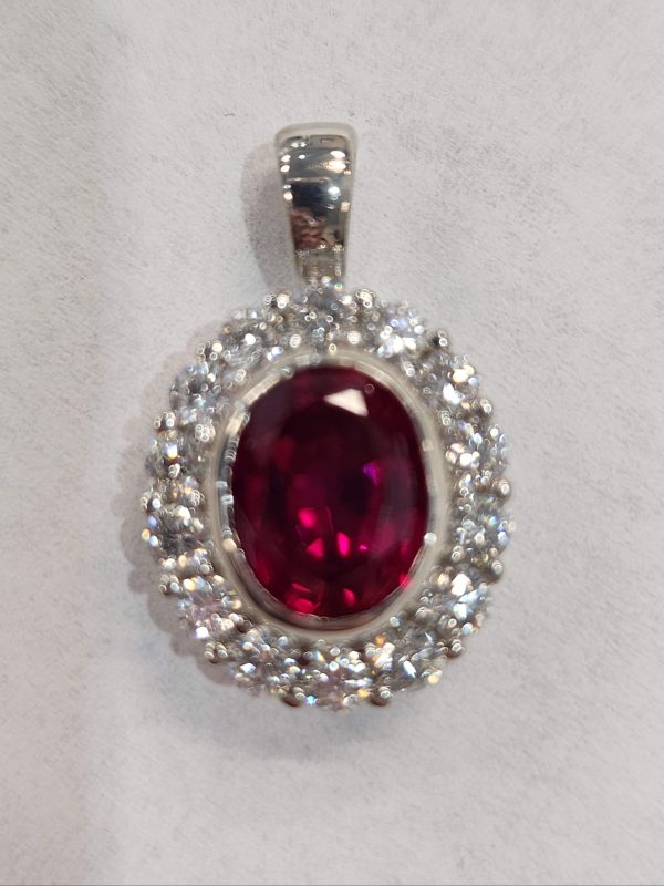14K WG APPROXIMATELY .50CT DIAMONDS WITH A 9X7 RUBY CENTER PENDANT. 2.6DWT.