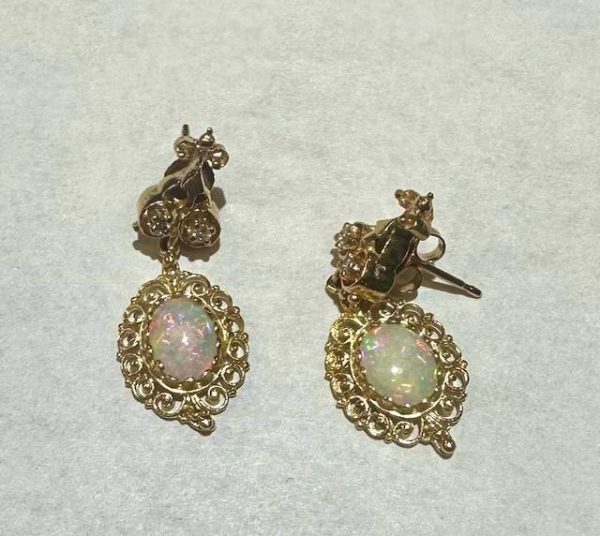 14K Y/G OPAL EARRINGS WITH OVAL OPAL AND 0.08 PTS OF RBC'S. 3.3 DWT.