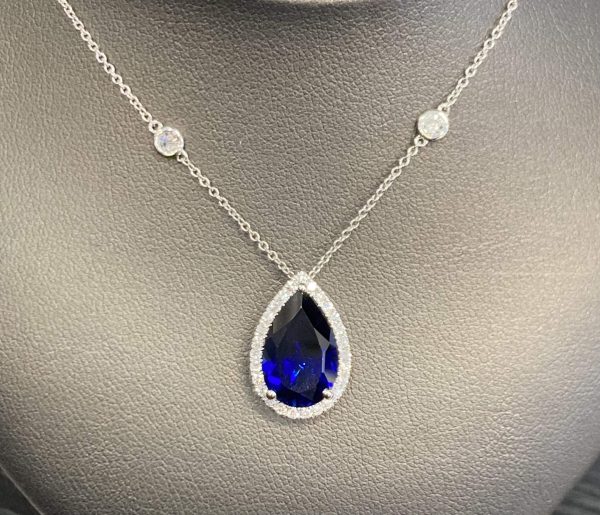 14K WHITE GOLD SAPPHIRE NECKLACE W/ ONE 5.06 CTS, 13.30x8.40MM LAB CREATED PEAR-SHAPED BLUE SAPPHIRE & 33 ROUND LGD WEIGHING APPROX 0.61 TCW. CHAIN: 18" DIA BY THE YARD. 2.7 DWT DIA COLOR: E-F, CLARITY: VS1-VS2 DIS # 522552 COMES WITH CARD & POUCH.