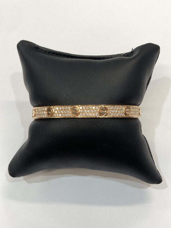 18K ROSE GOLD NATURAL DIAMOND CARTIER INSPIRED "SCREW STYLE" BANGLE BRACELET FEATURING 2.25 CTS OF ROUND BRILLIANT CUT DIAMONDS. SIZE 19. 18.9 DWT.