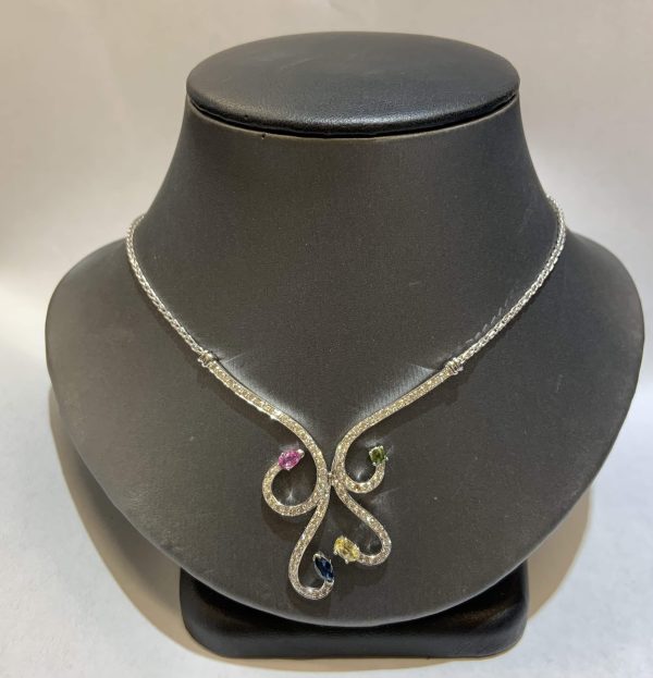 14K W/G 20" DIAMOND SWIRL DESIGN FASHION NECKLACE FEATURING 1.00 OF ROUND BRILLIANT CUT PAVE SET DIAMONDS AND 4 MULTI-COLOR SAPPHIRES. 5.2 DWT.