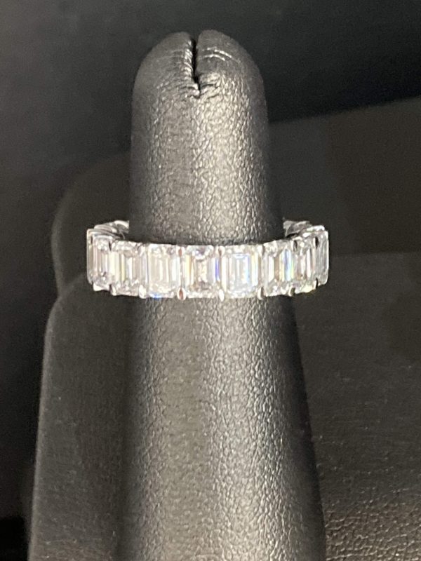 18K WHITE GOLD ETERNITY BAND W/ 19 EMERALD CUT DIAMONDS WEIGHING APPROX. 7.85 TCW. D - E, VS1 - VS2, 4.6 DWT, SIZE 5